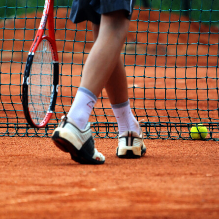 view of tennis players legs by the net