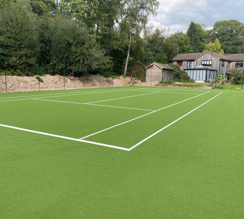 tennis court next to a house
